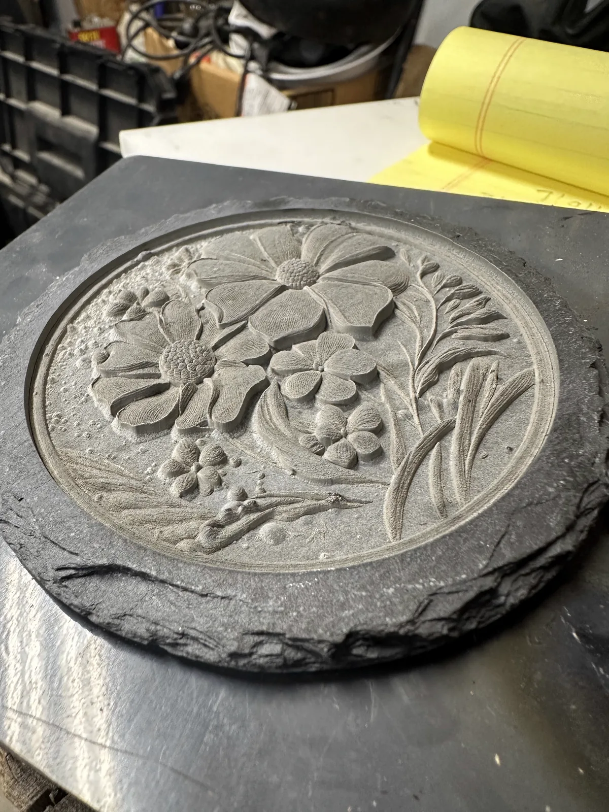 Floral engraving on round slate