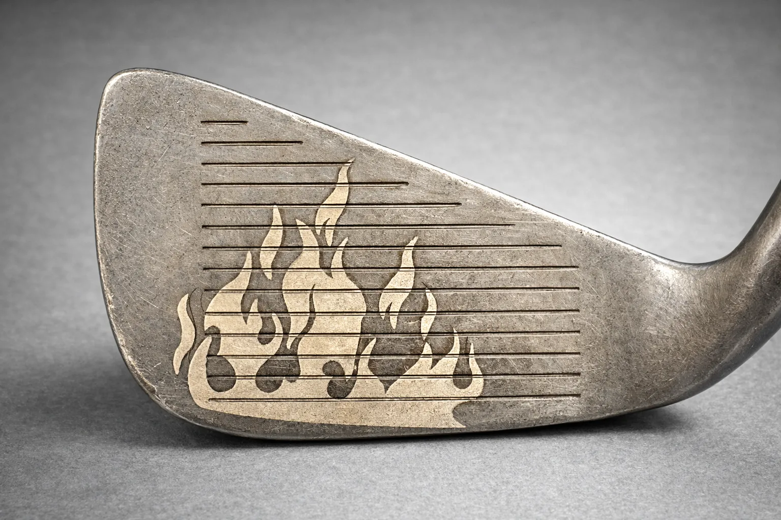 Flame design engraved into a golf putter